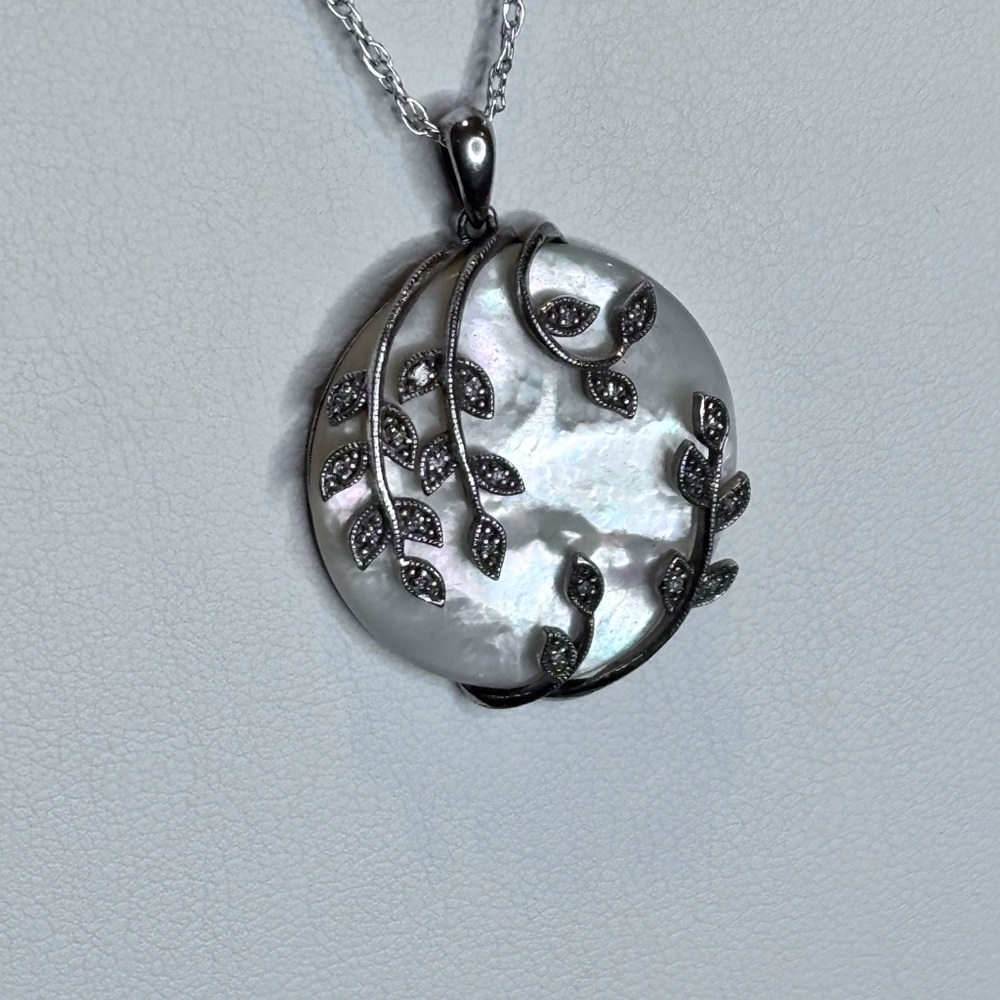 Elegant MOP pendant is stunning with its MOP base with SS/ diamond accents.